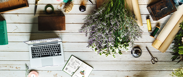 Desk with lavender flowers and a laptop