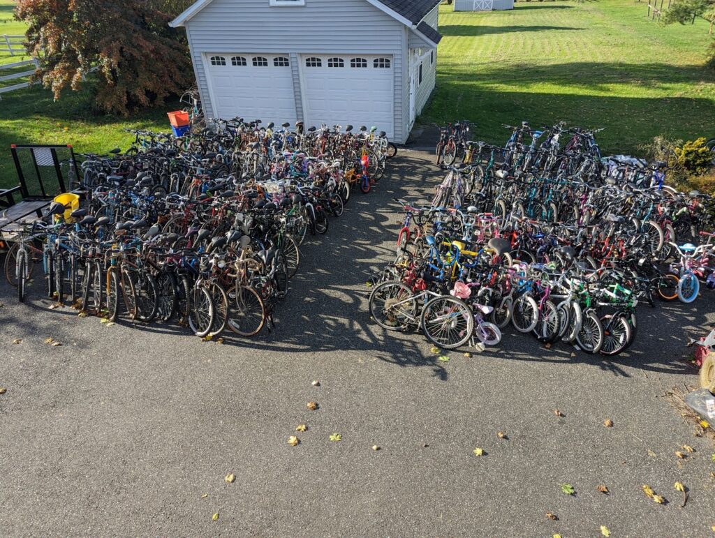 Hundreds of bikes sitting outside waiting for a person who needs one.