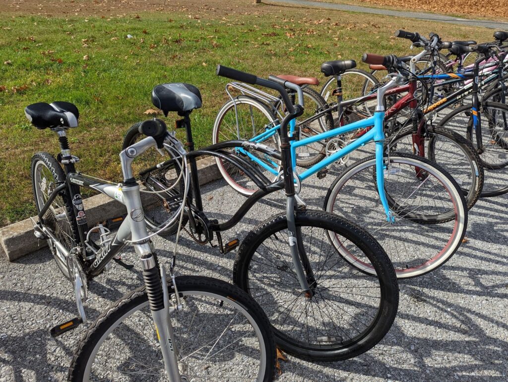 A row of bicycles ready to be picked up.